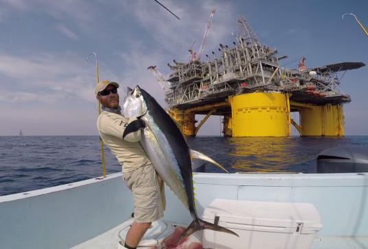 Capt. Charlie Ellis with a yellowfin tuna caught at URSA